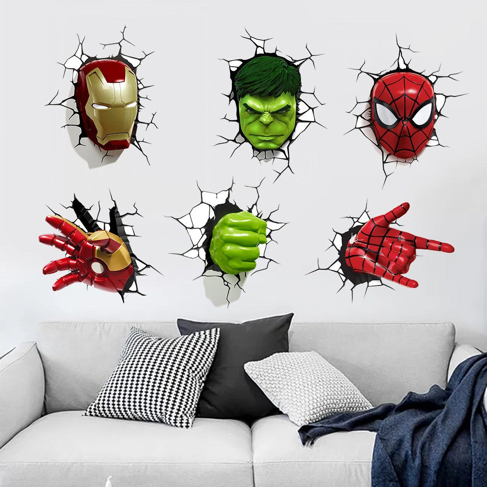 Six Marvel superhero wall decals showing Iron Man, Hulk, Spider-Man, and alternate views of their masks and hands, applied to a white wall above a modern gray sofa with decorative pillows.