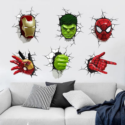 Six Marvel superhero wall decals showing Iron Man, Hulk, Spider-Man, and alternate views of their masks and hands, applied to a white wall above a modern gray sofa with decorative pillows.
