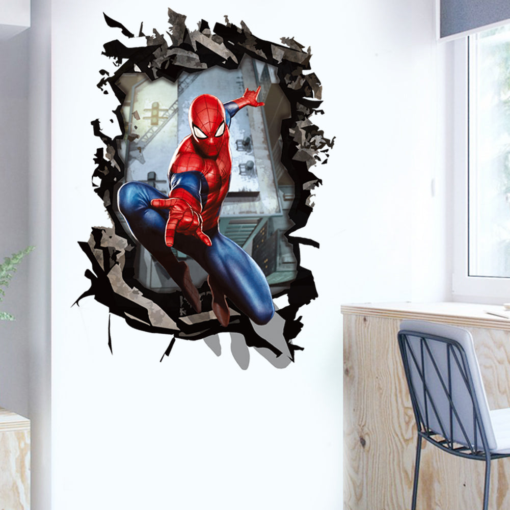 Spider-Man 3D wall decal showing the superhero breaking through a wall, displayed on a white wall in a room setting with a desk and chair visible.